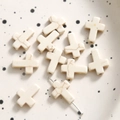 Macro detail of cross shaped white turquoise beads with natural marble texture for DIY jewelry - Cross / 1 Piece / White