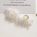 Detail of fan-shaped earring with iridescent crystals and woven white pearls - White