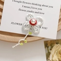 Detailed view of a handmade beaded floral brooch featuring white petals and green leaves - Flower with Green Leaf Stem (Style 2)