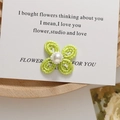 Detail of hand-woven green beaded flower earring with central pearl on vintage card - Light Green Woven Flower (Style 4)