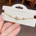 Elegant gold clover bracelet with crystal pavé, white pearls and adjustable chain - Gold