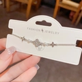 Silver bracelet with hollow diamond-set clovers and white pearls on delicate chain - Silver