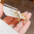 Detail of golden screw-back clip-on earrings with soft transparent silicone pads - Pattern 1 (Spiral Adjustment) / Gold