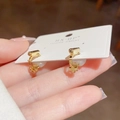 Minimalist gold metal hoop earrings featuring elegant white pearls in a hand-held display - Pattern 2 (Pearl Embellished) / Gold