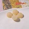 Detail of 12mm semi-transparent creamy jelly resin cabochons with smooth round surface - Yellow
