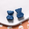 Macro detail of dark blue matte bear charms showing front texture and flat back - Blue