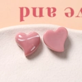 Macro view of glossy pink resin heart charms with a smooth polished finish on white ceramic - Pink Cartoon Star Clip (My Melody)