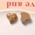 Close-up of heart-shaped caramel resin charms with white marble texture on a tray - Brown (One Piece)