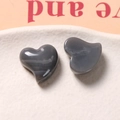 Detail shot of heart-shaped dark grey resin pieces with smooth polished texture for DIY crafts - Iron Gray