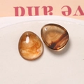 Macro shot of amber resin water drop charms with ink-wash texture for DIY jewelry making - Amber