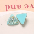 Macro view of mint green triangle resin earrings with gold leaf foil inlay and smooth finish - Blue