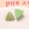 Macro shot of triangular resin earrings with gold leaf and light green wave patterns - Avocado Green