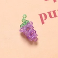 Macro shot of 3D crystal grape bead charms made with purple and green faceted acrylic beads - Deep purple