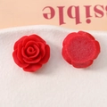 Macro view of 20mm red resin rose charms showing 3D front petals and flat back base - Red