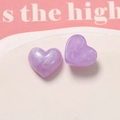 Close-up of heart-shaped glitter resin charms with pearlescent purple finish for DIY crafts - Purple