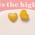 Detail of yellow glitter heart resin charms with pearlescent finish for DIY jewelry - Orange