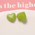 Macro shot of green glitter resin heart charms with pearlescent finish for DIY crafts - Green