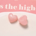 Macro shot of pink glitter heart-shaped resin charms for DIY jewelry and hair accessories - Pink
