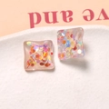 Macro shot of square resin earrings with colorful iridescent glitter inside - Glitter Sequin Square Style