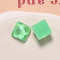 Detailed macro view of mint green resin square charms with a marbled cat-eye effect - Water Wave Style / Green