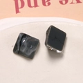 Macro shot of square resin pieces with black and grey marble texture on ceramic plate - Marble Pattern Style / Black