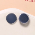 Close-up of dark blue matte square resin studs with a translucent jelly finish - Navy Blue