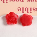 Detailed macro view of red marble resin rose charms for DIY handmade jewelry crafting - Tie-Dye Red