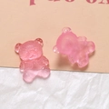 Macro detail of pink translucent resin bear charms with knitted texture and smooth back - Pink