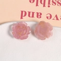 Detail shot of two pink resin roses with gold foil flakes for DIY jewelry and crafts - Pink