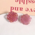 Detailed macro of resin rose charms with embedded gold foil for DIY jewelry making - Rose Red