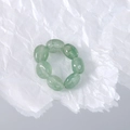 Detail of stretch ring made with green oval natural stone beads on crumpled paper - Green / Green