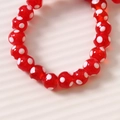 Dettaglio macro di perle di vetro rosse 10mm a pois bianchi per creazioni fai da te - 1 Pezzo / Rosso