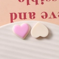 Macro shot of colorful resin heart charms for DIY jewelry and hair accessories - Pink Purple