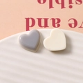 Detail von minimalistischen Harz-Herzanhängern in Grau und Creme für DIY-Schmuck - Grau