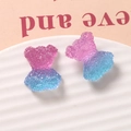 Dettaglio macro di orsetti in resina sfumata con trama granulosa per accessori fai-da-te - Fucsia e Blu