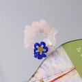 Macro detail of handmade beaded ring featuring pink natural stones and a blue glass flower - Blue Flower