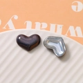 Macro detail of glossy heart-shaped pearl resin beads for DIY jewelry and phone case decor - Black