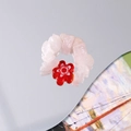 Detailed macro shot of handmade beaded ring with pink natural stones and floral glass charm - Red Flower