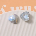 Macro shot of geometric faceted heart charm with iridescent pearlescent finish - Silver White