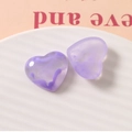 Close-up of purple marble heart resin charms on white ceramic tray for DIY jewelry making - Purple