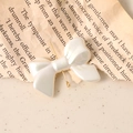 Pearlescent white bow DIY accessory with gold metal base on vintage paper - Iridescent Pearl White