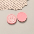 Close-up of pink resin smiley face charms showing both glossy front and flat back details - Pink
