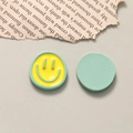 Detail of yellow and green resin smiley face charms for DIY jewelry and hair accessories - Yellow & Green