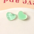 Detailed macro view of mint green resin heart charms with unique water ripple textures - Green