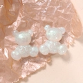 Macro detail of two white glitter resin bears with iridescent sequins for DIY crafts - Bear