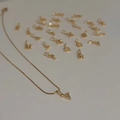 Detailed view of 18k gold plated letter V pendant with sparkling zircons on a thin chain - Letter B
