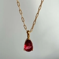 Elegant 18k gold plated titanium steel necklace featuring a pear-cut red zircon pendant - July