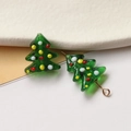 Macro detail of a green glass Christmas tree charm with colorful dots for DIY jewelry crafts - Christmas Tree