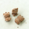Close-up of three milk tea brown flocked kitten charms for DIY crafts and jewelry making - Dark Coffee Cat Charm Style