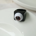 Detail shot of a square resin ring featuring a realistic brown eyeball in dark gothic style - Black